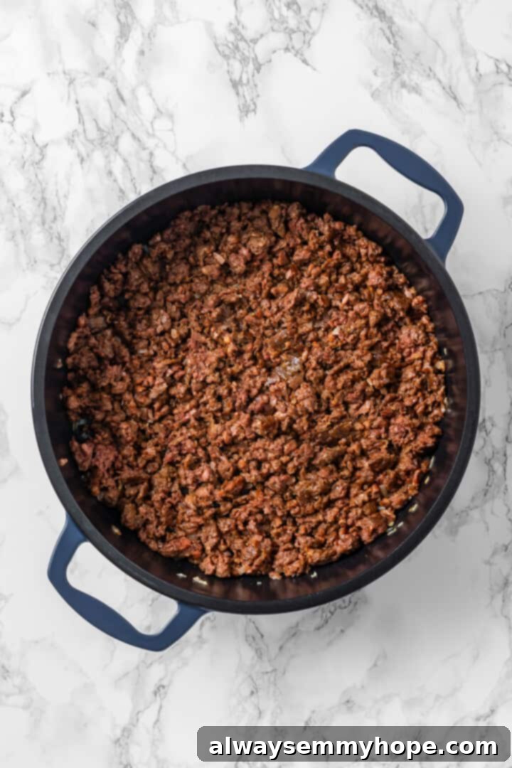 Vegan ground beef browning in a skillet. Overhead view of vegan ground beef in skillet