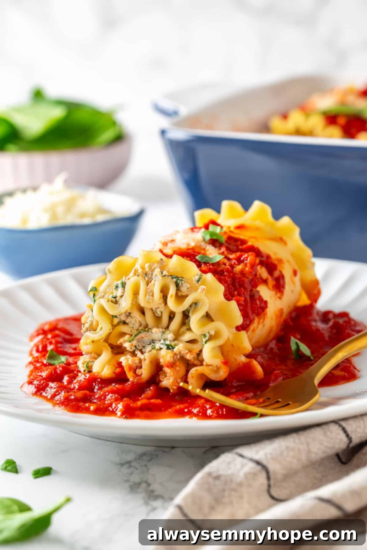 Side view of a perfectly portioned vegan lasagna roll-up on a white plate with a fork, garnished with fresh basil.
