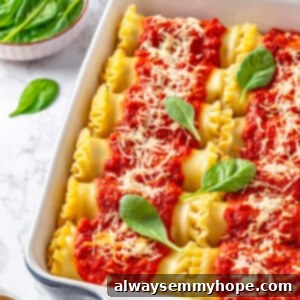 Spinach ricotta lasagna rolls in blue ceramic baking dish, with fresh basil leaves scattered on top as garnish