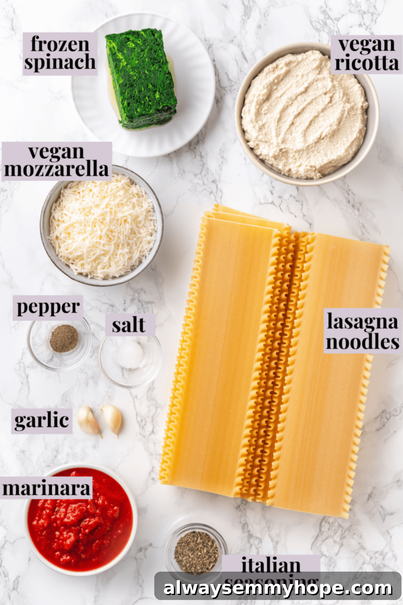 Overhead view of all ingredients for vegan lasagna roll-ups laid out and labeled on a rustic wooden table.
