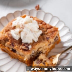 Golden Pumpkin Streusel Bake 2 Pumpkin dump cake on plate with fork and dollop of whipped cream on top