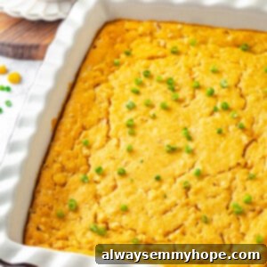 Vegan Cornbread Pudding in a white casserole dish with green onions on top