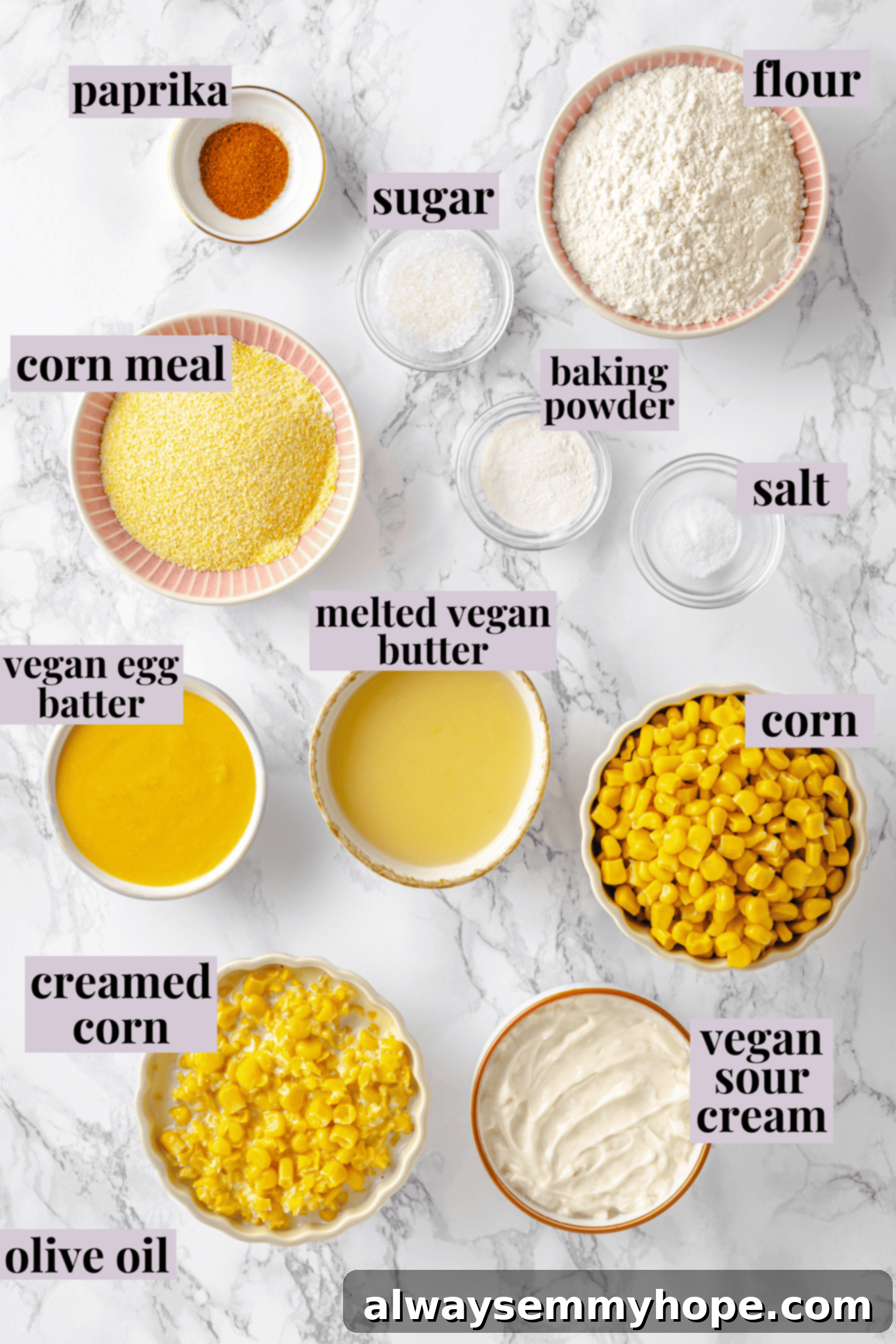 An overhead view of all the essential ingredients for making vegan cornbread pudding, neatly arranged with clear labels for easy identification.