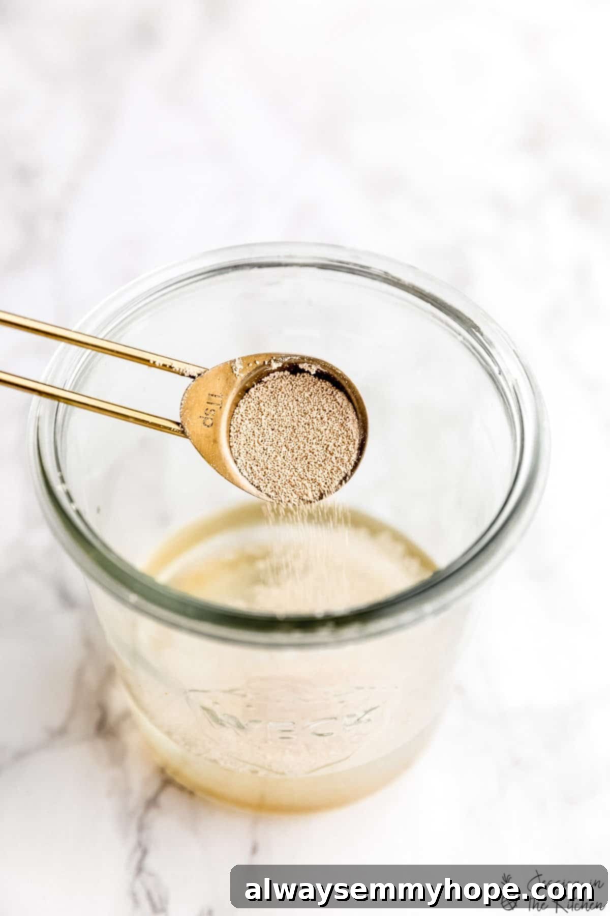 A spoon pouring yeast into water