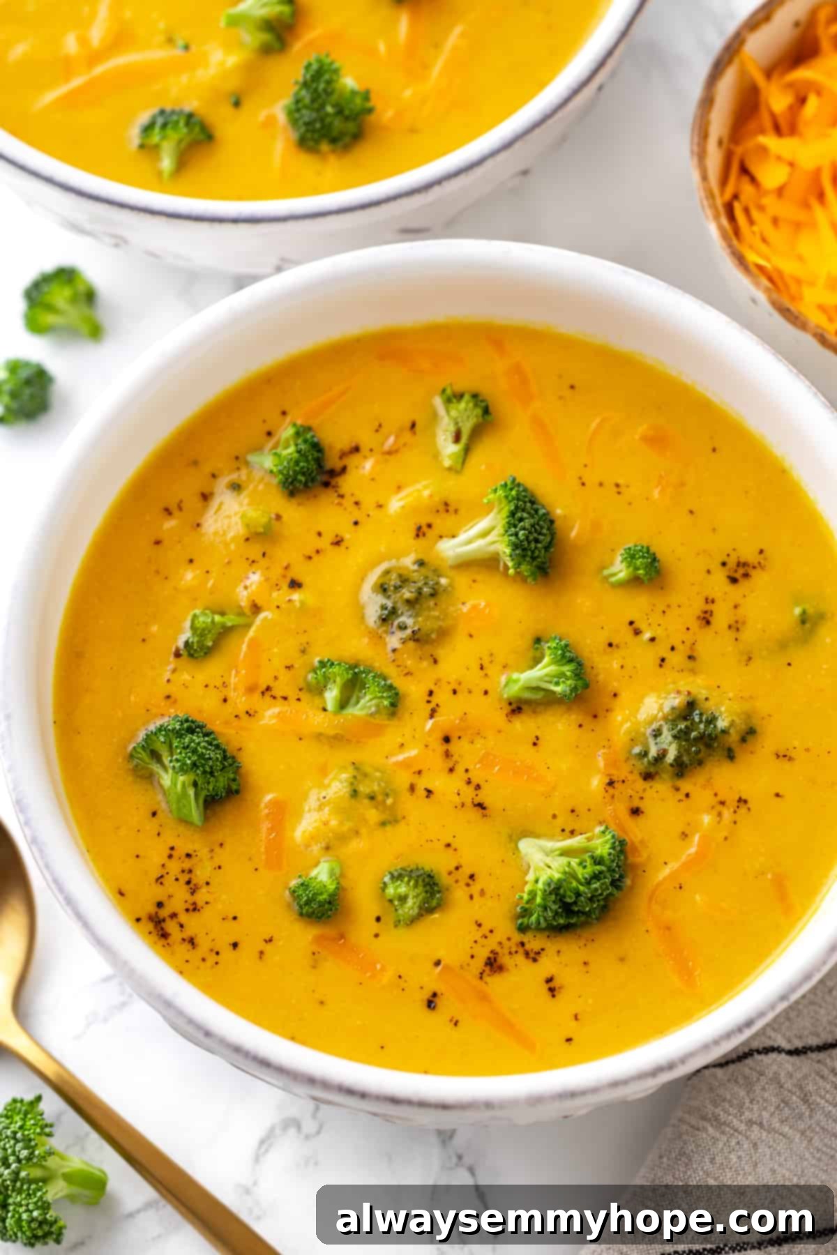 Overhead view of a bowl of rich, creamy vegan broccoli cheddar soup, ready to be enjoyed. Overhead view of a single bowl of rich, creamy vegan broccoli cheddar soup, showcasing its vibrant color and smooth texture.