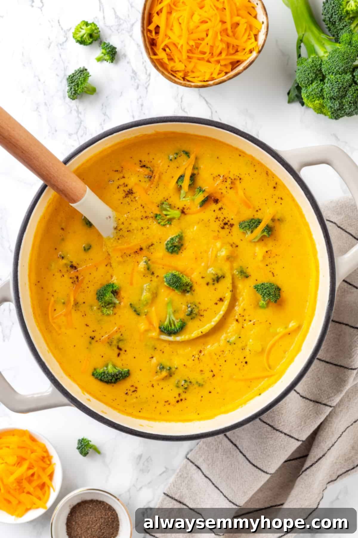 A pot full of rich cheese broth and tender broccoli florets, creating a delicious vegan broccoli cheddar soup that's ready in minutes! Overhead shot of a large pot filled with creamy vegan broccoli cheddar soup, ready to be served.