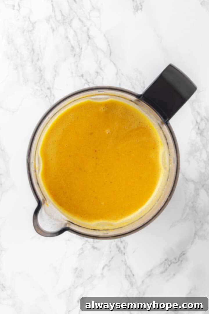 The pureed, smooth, and creamy base for the ultimate vegan broccoli cheddar soup! Overhead view of the smooth, creamy pureed base for vegan broccoli cheddar soup in a pot.