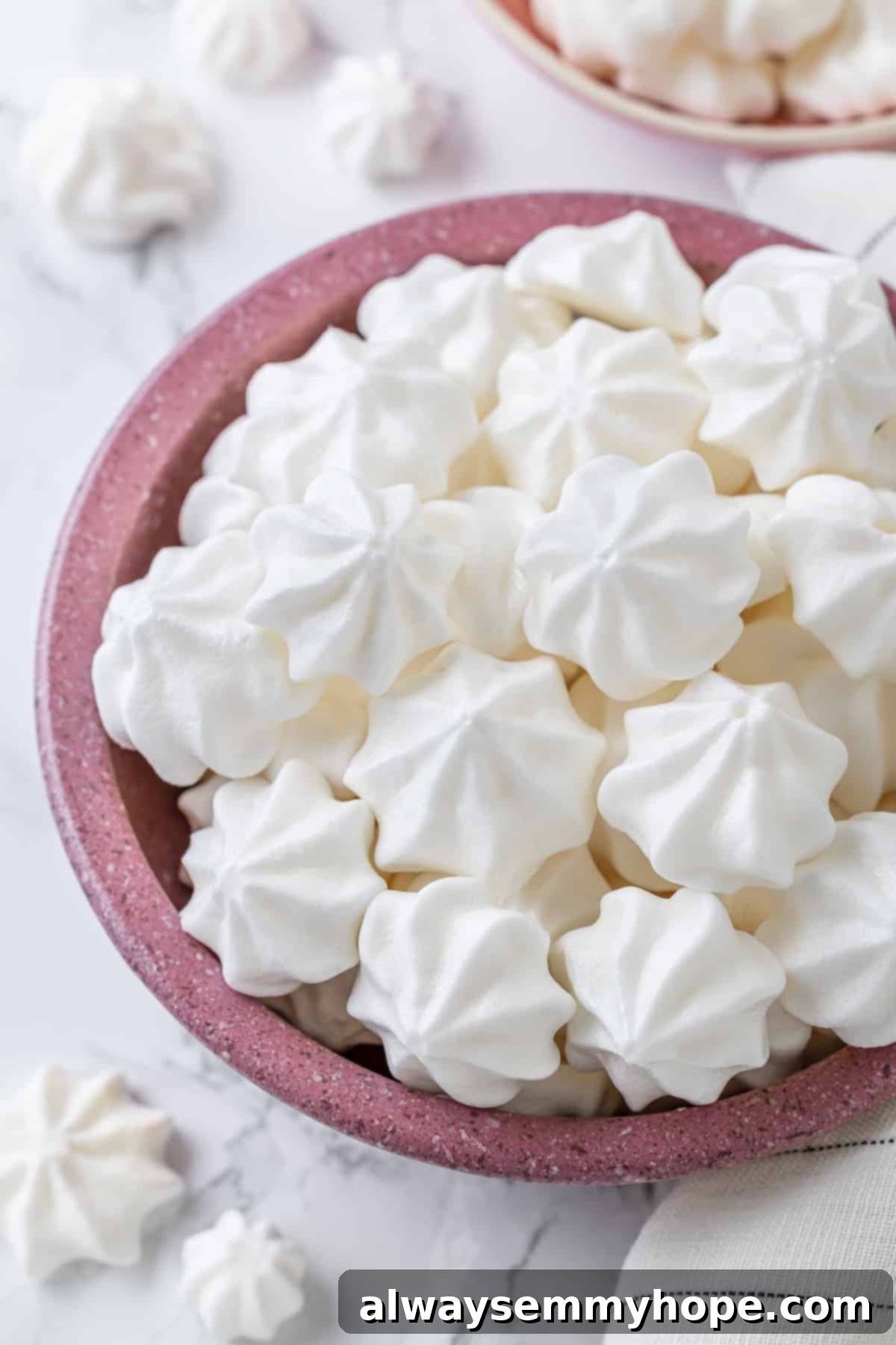 Aquafaba is a miracle worker in vegan baking. But what is aquafaba? And how do you use it? Here’s everything you need to know! Vegan meringues in pink bowl