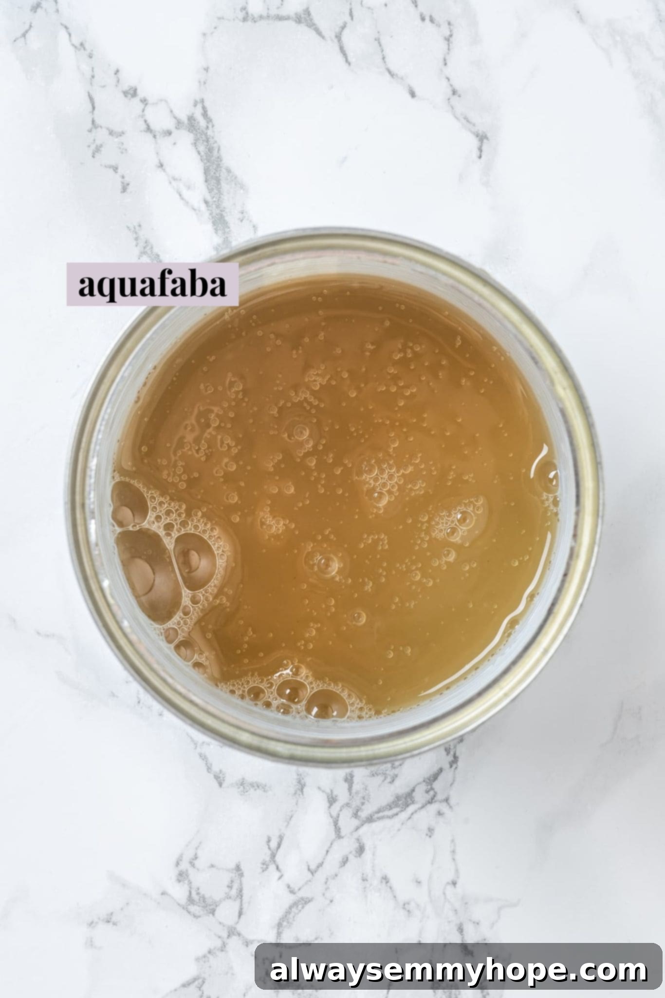 Aquafaba is a miracle worker in vegan baking. But what is aquafaba? And how do you use it? Here’s everything you need to know! Overhead view of liquid from can of chickpeas
