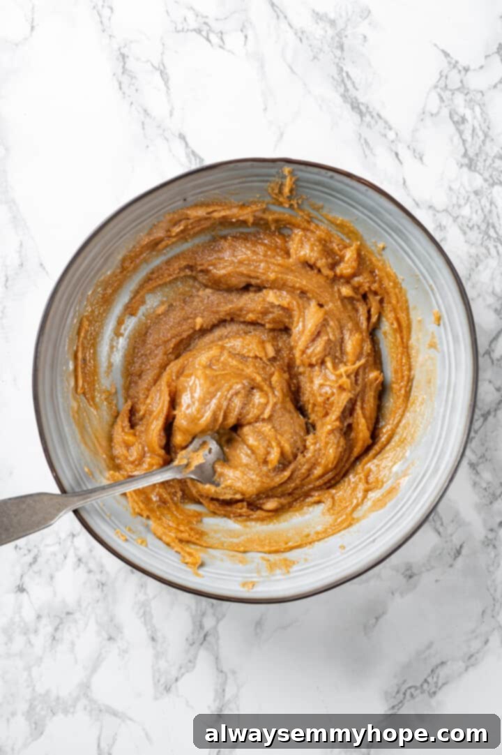 Peanut butter and maple syrup mixture in bowl with spoon