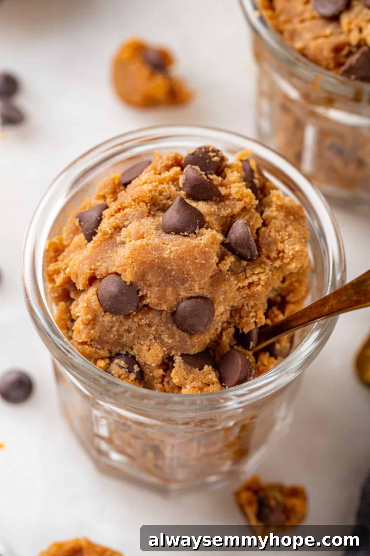 Jar of chocolate chip protein cookie dough with spoon