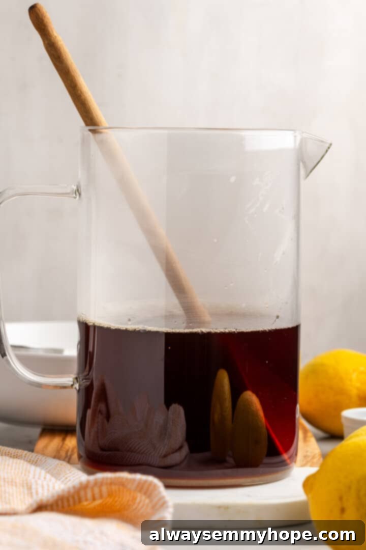 Gently stirring the sugar, baking soda, and tea concentrate in a pitcher until all ingredients are fully dissolved and combined.