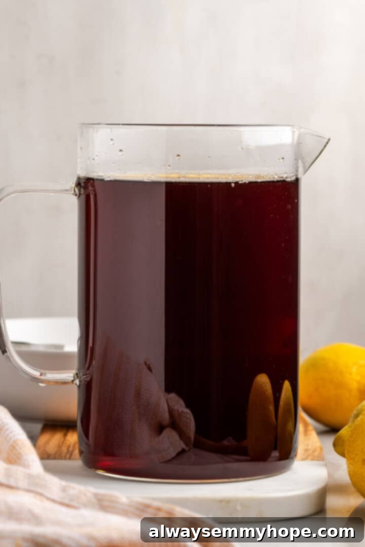 A large pitcher filled with freshly made Southern sweet tea, perfectly brewed and ready for chilling.