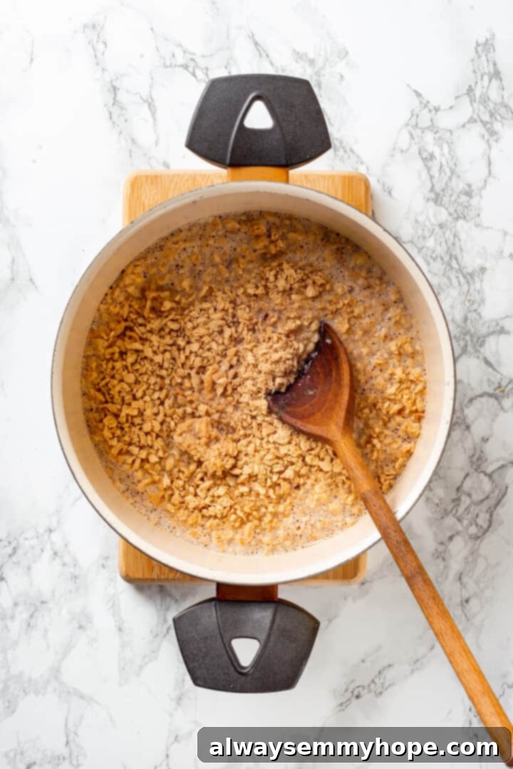 Overhead view of TVP granules being rehydrated in a pan of hot vegetable broth.