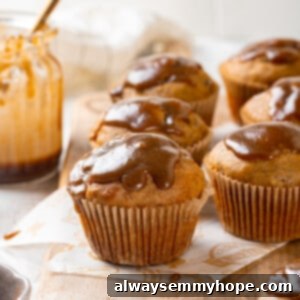 Spiced Pumpkin Banana Muffins 2 Glazed pumpkin banana muffins on wooden board