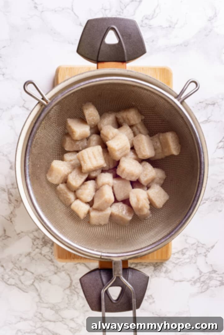 Overhead view of boiled cauliflower gnocchi in colander