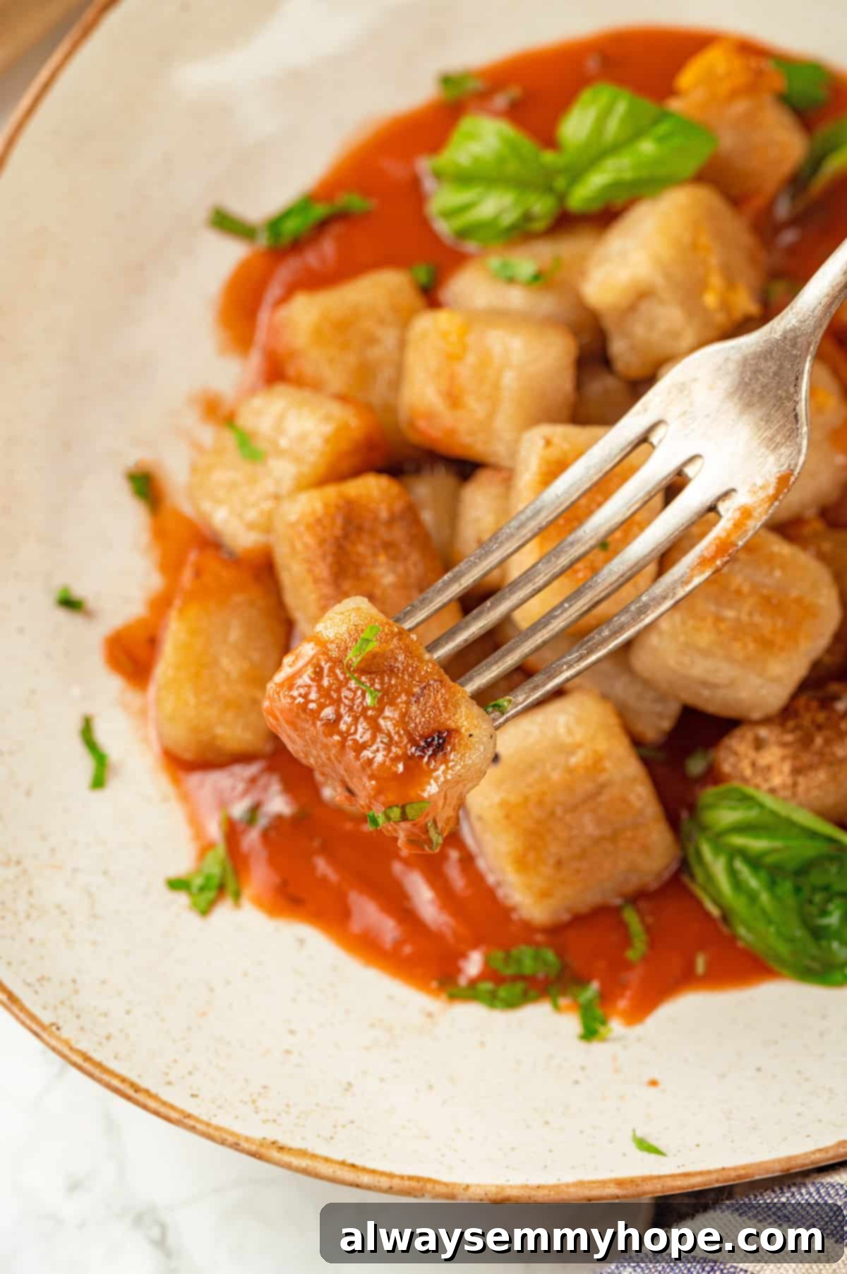 Cauliflower gnocchi with marinara on fork