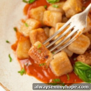 Cauliflower gnocchi with marinara on fork