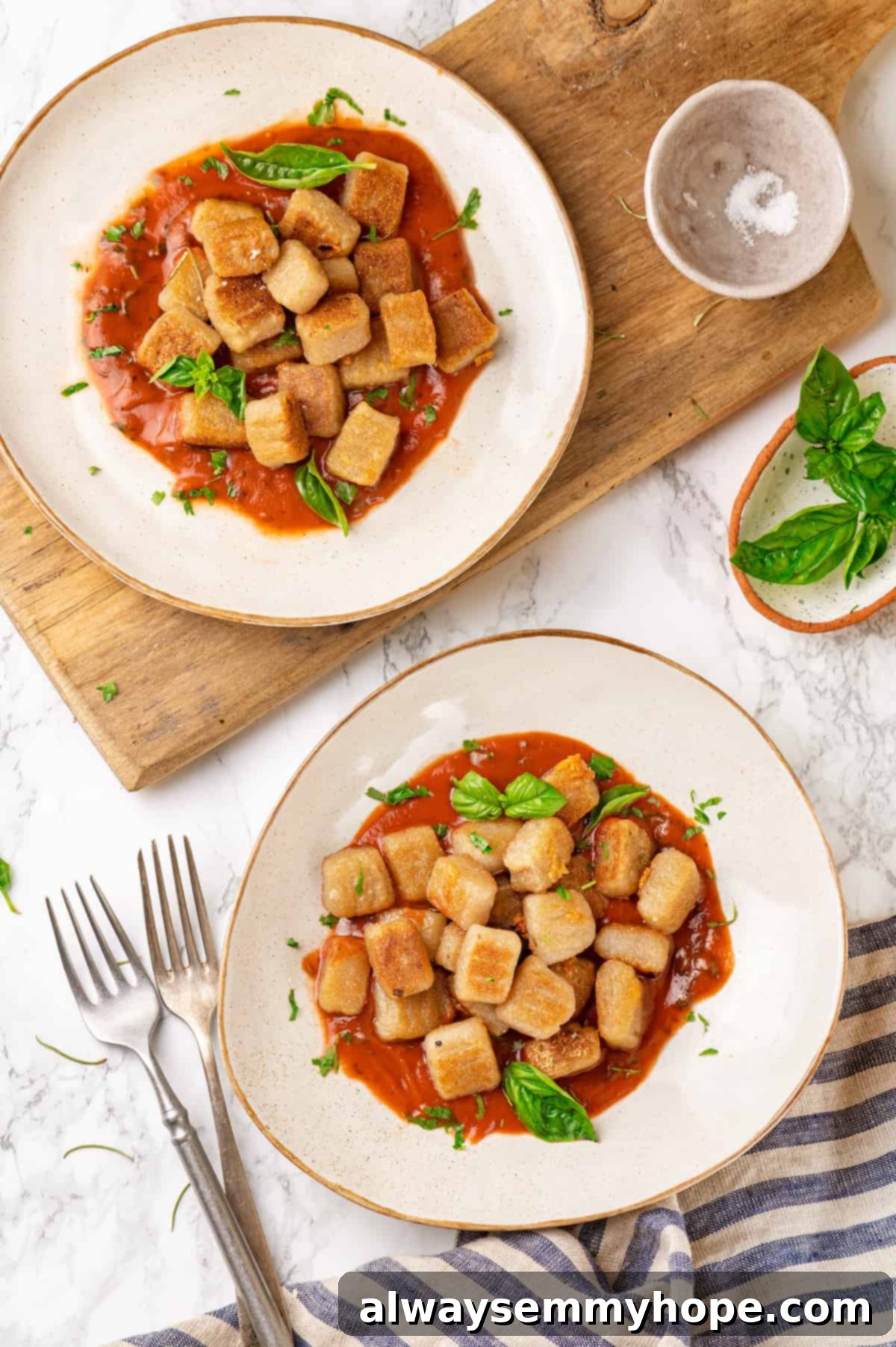 Overhead view of cauliflower gnocchi with marinara on two plates