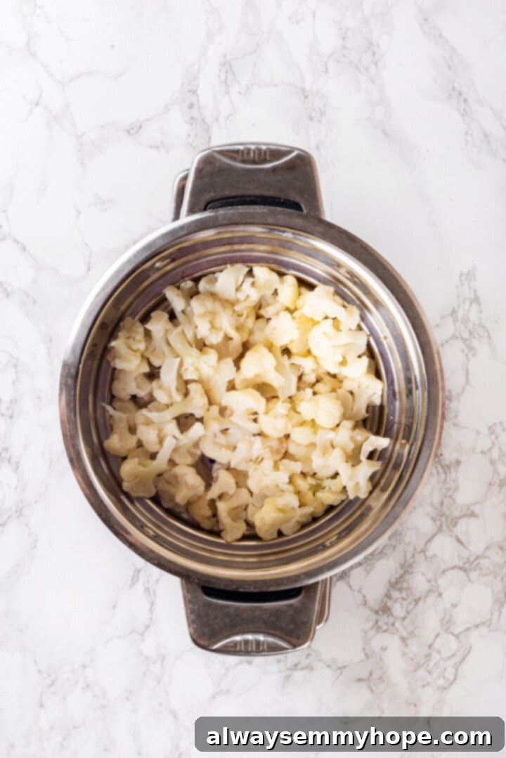 Overhead view of cauliflower in steamer basket