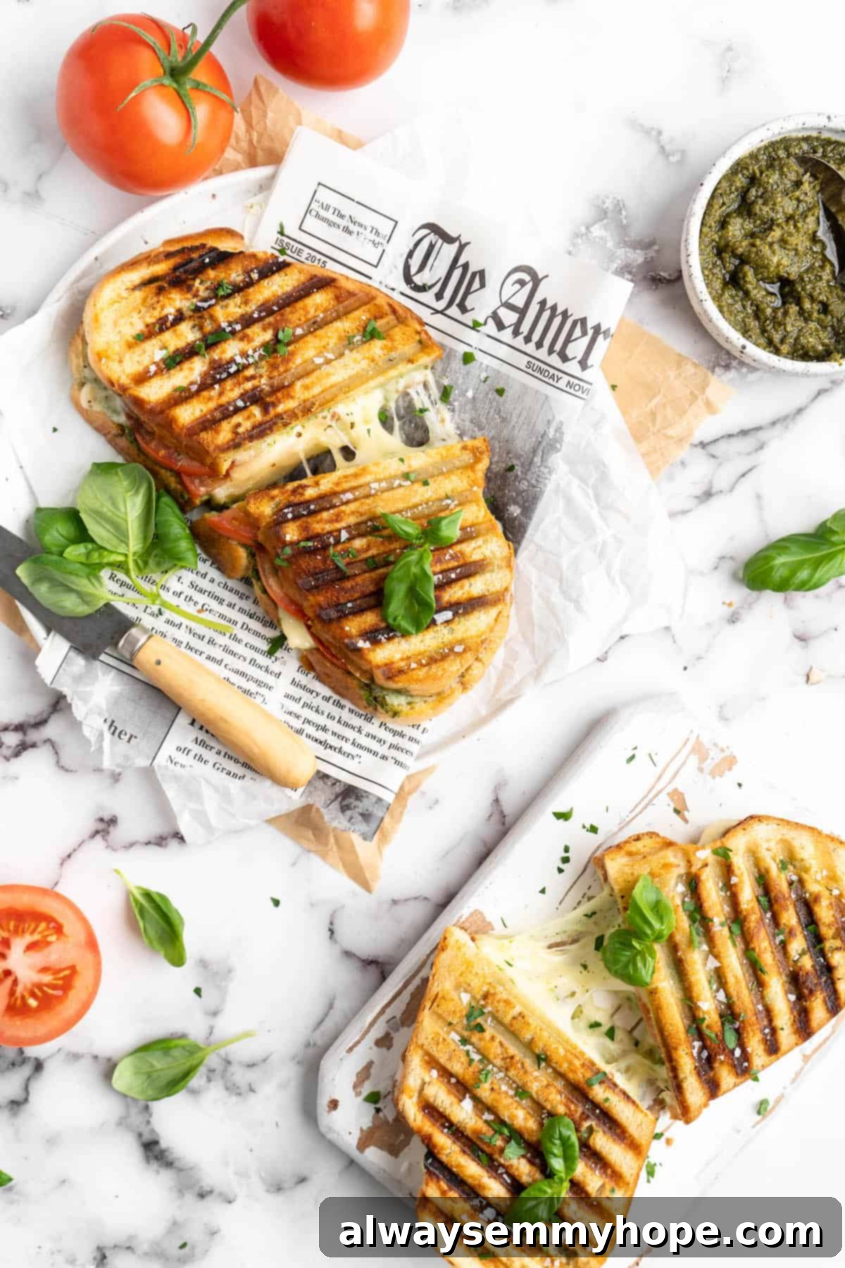 Vegan caprese sandwiches, cut in half to show stretchy mozzarella