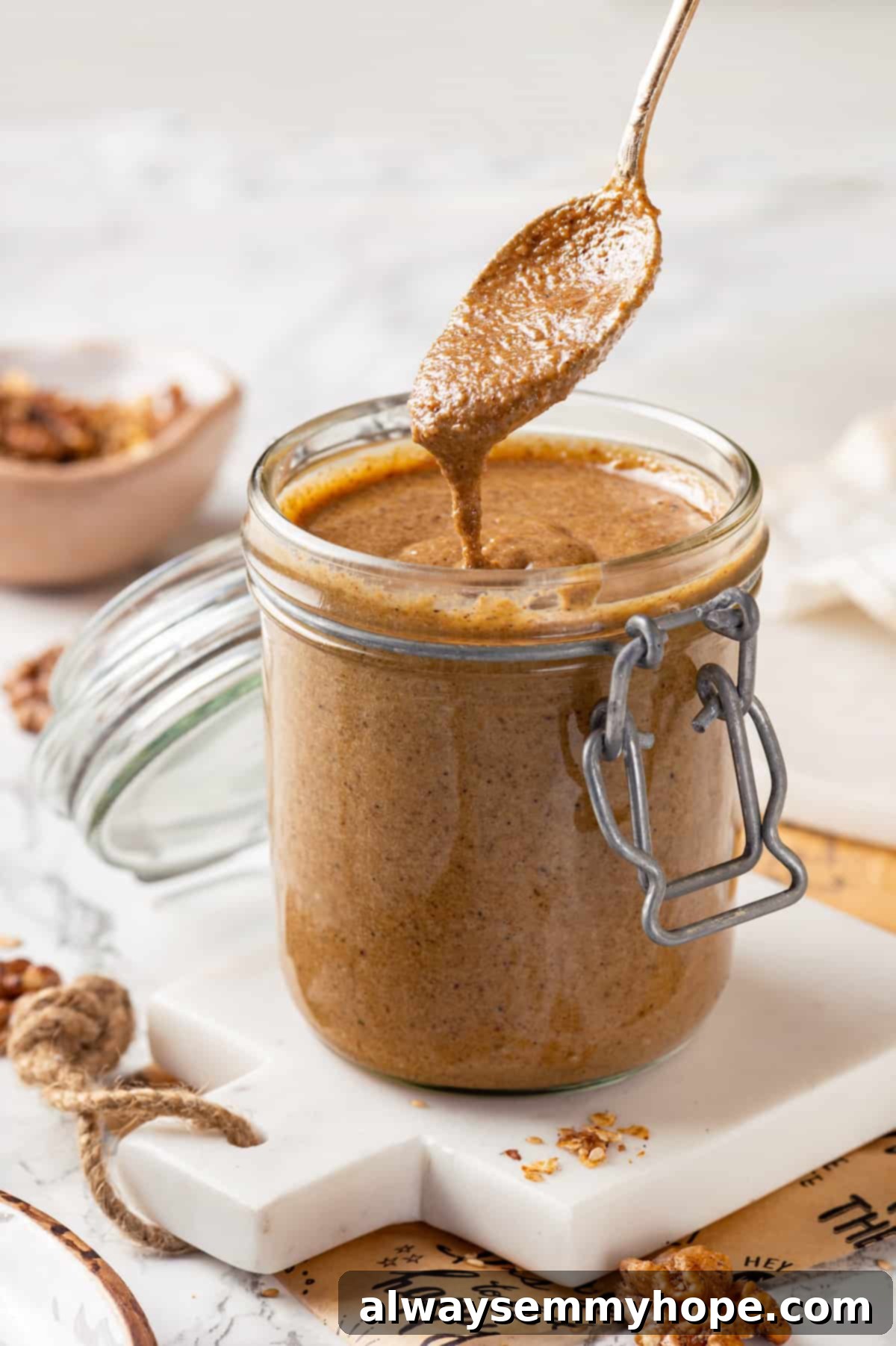 This easy homemade granola butter recipe is a toasty blend of oats, seeds, nuts and cozy spices. Spread it on toast, fruit, waffles and more! Drizzling granola butter back into jar