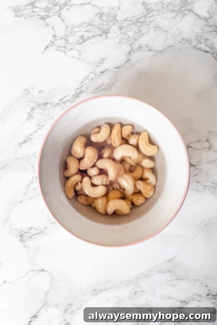 Overhead view of cashews soaking in bowl of water