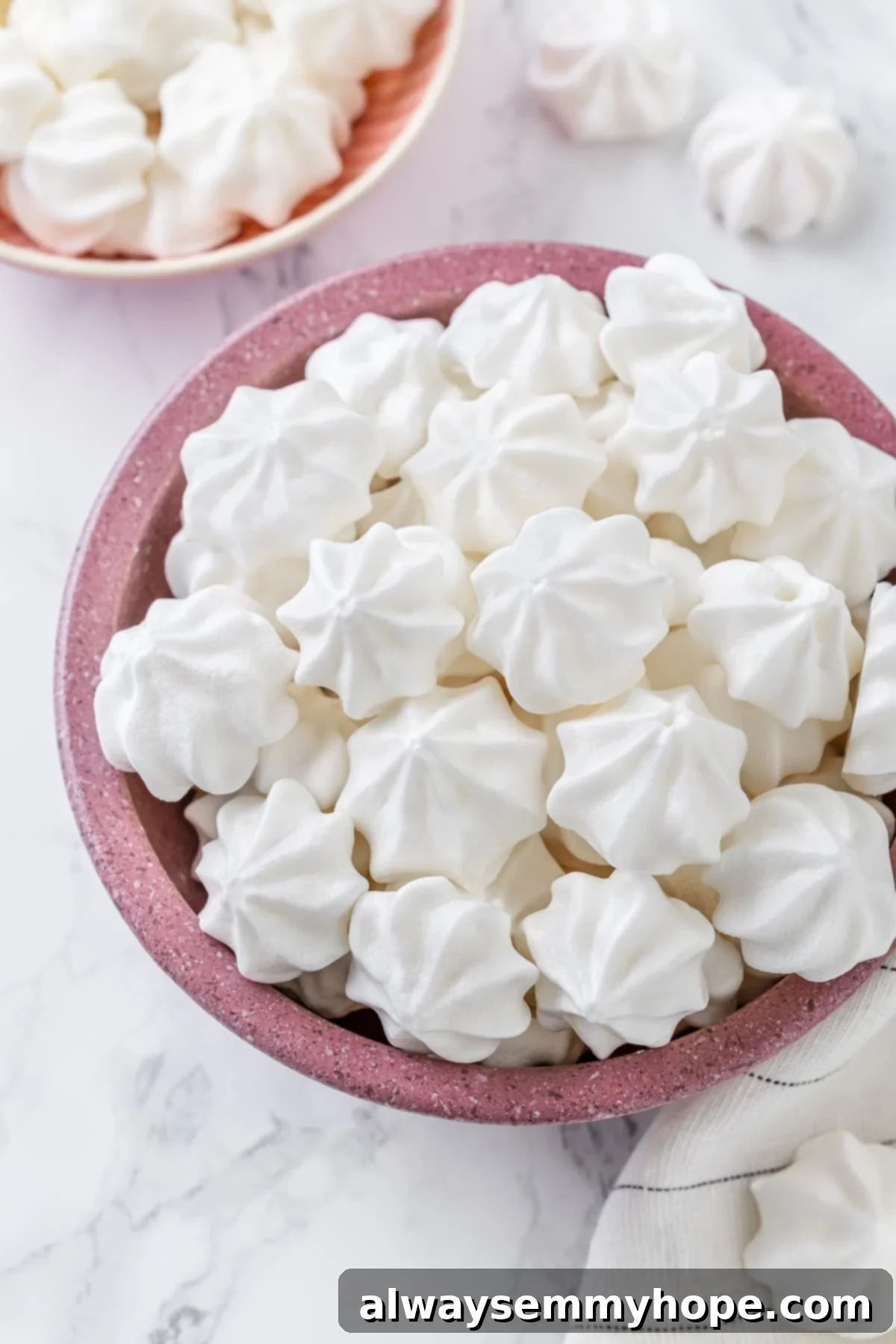 Vegan aquafaba meringues in pink bowl