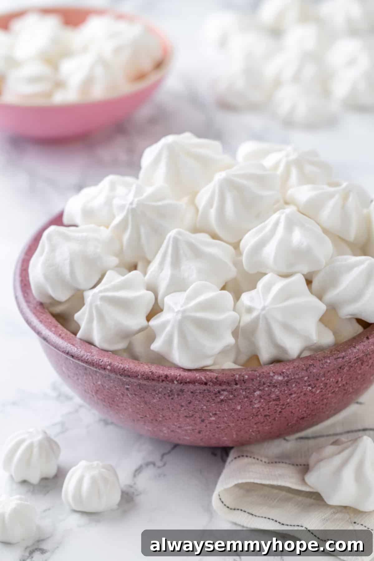 Vegan aquafaba meringues in pink bowls