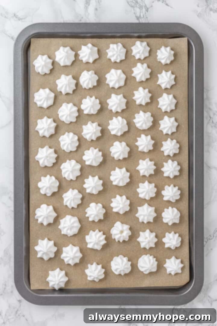 Vegan meringues on parchment lined baking sheet