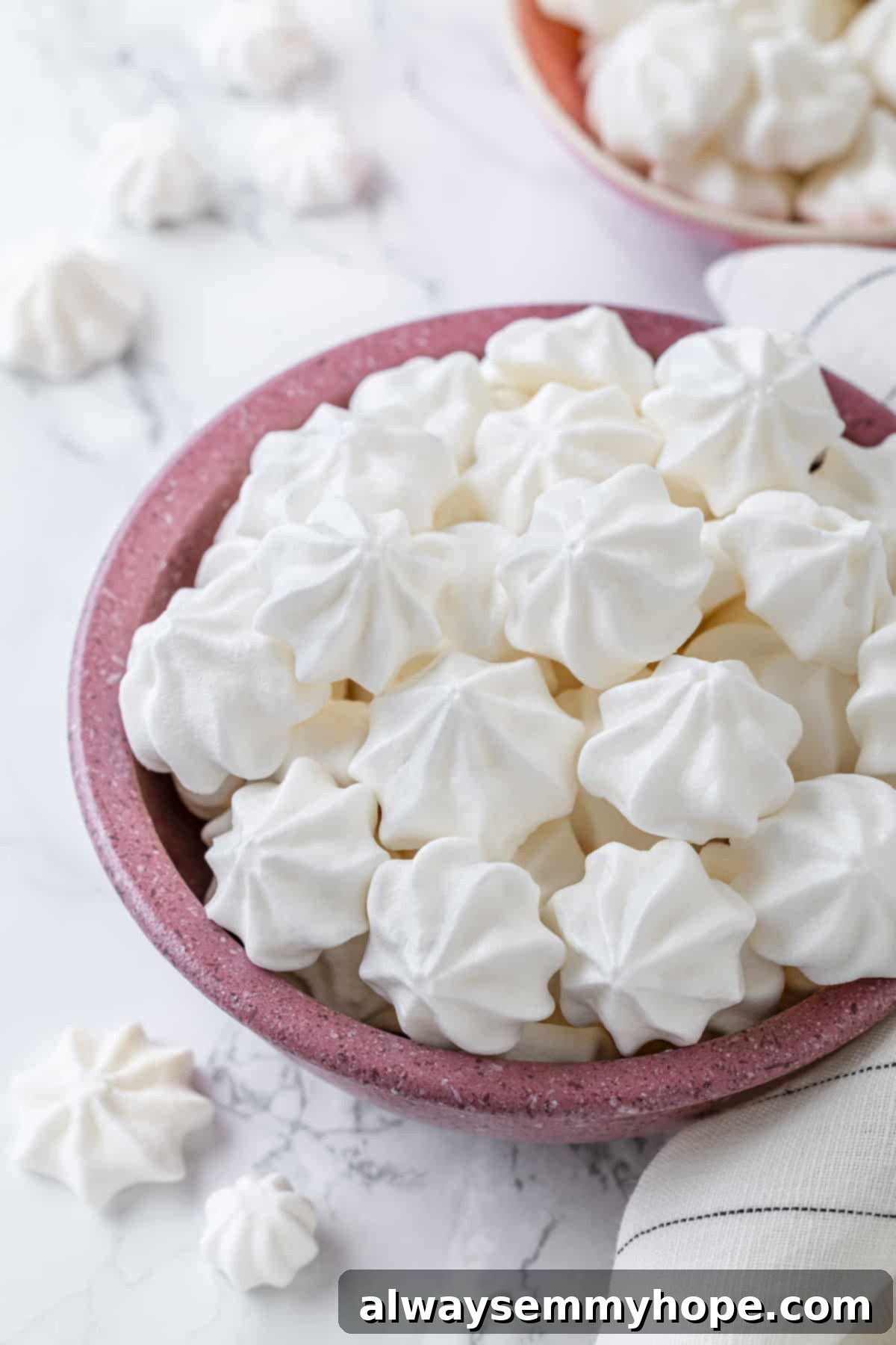 Vegan aquafaba meringues in pink bowls
