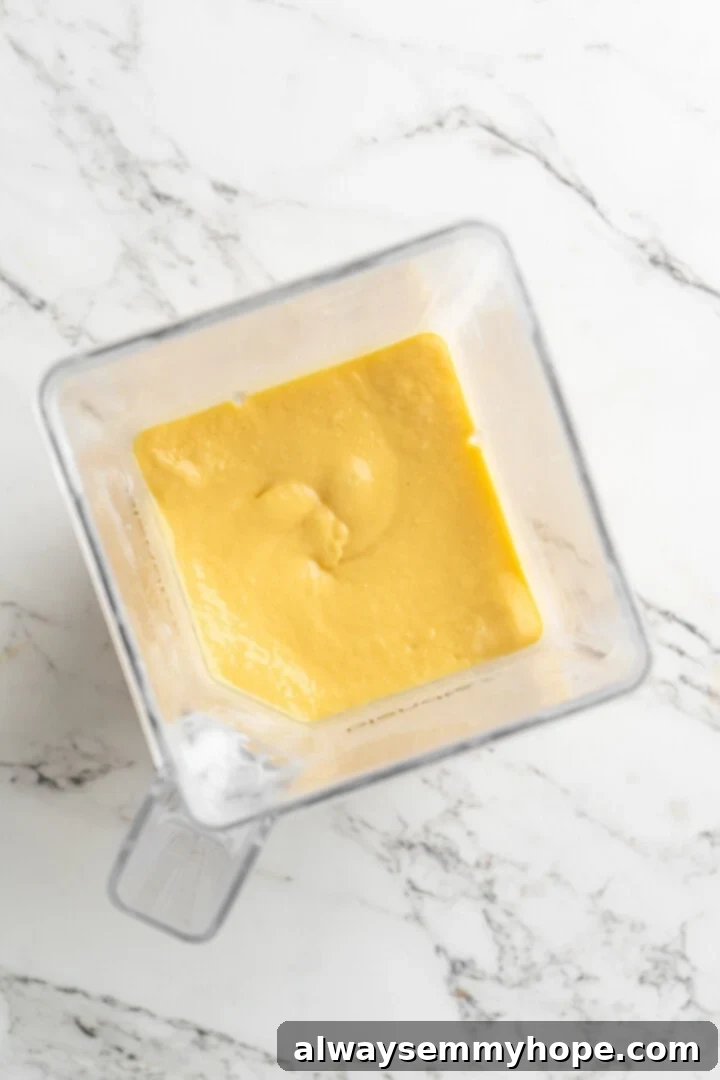 Overhead view of mango smoothie in blender