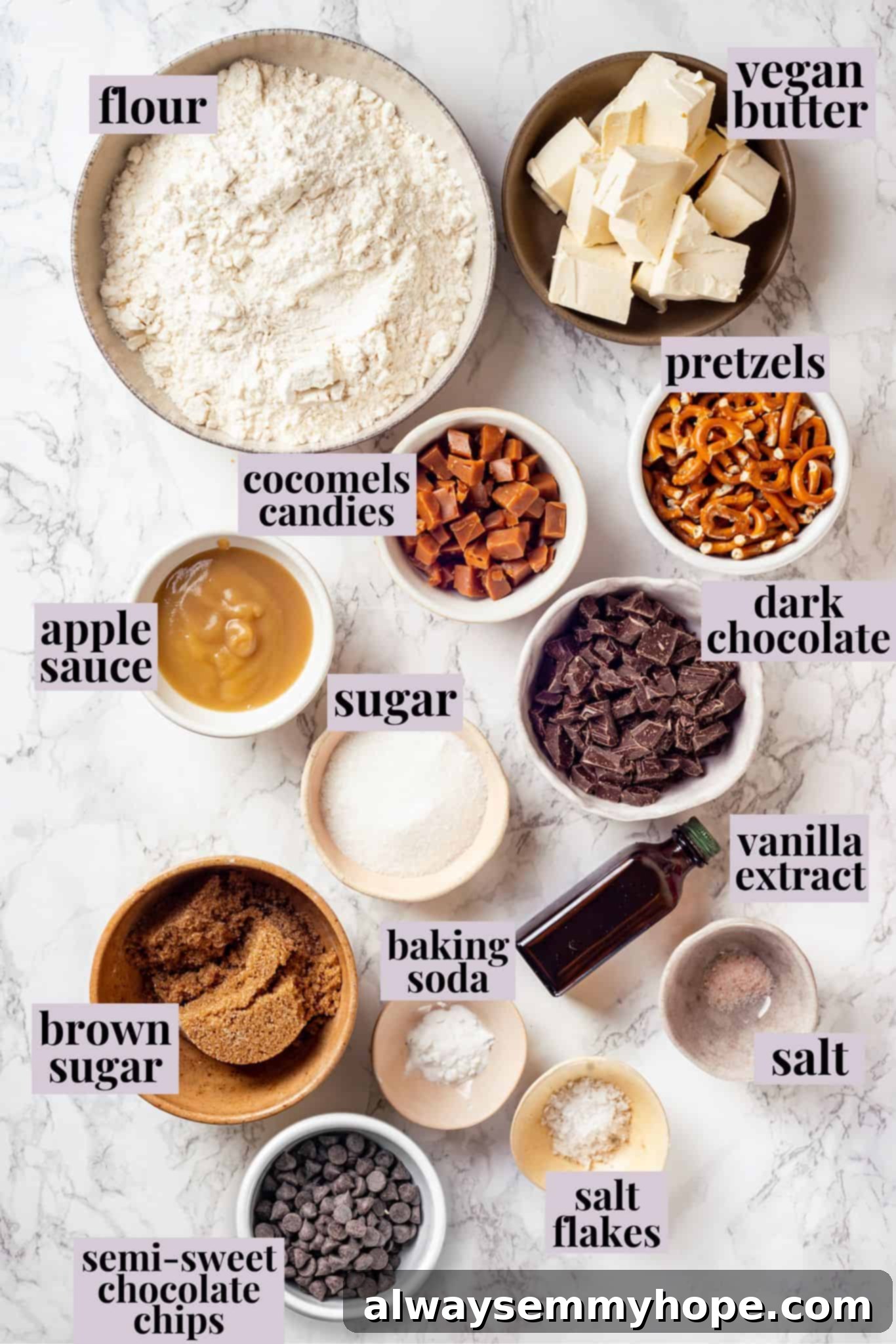 With an irresistible mix of chocolate, caramel and crispy pretzels, these kitchen sink cookies are easy to whip up and even easier to devour! Overhead view of all the ingredients for vegan kitchen sink cookies neatly laid out and labeled before mixing.