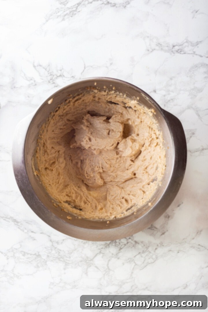 With an irresistible mix of chocolate, caramel and crispy pretzels, these kitchen sink cookies are easy to whip up and even easier to devour! Overhead view of creamed vegan butter and sugars in a stand mixer bowl, light and fluffy.