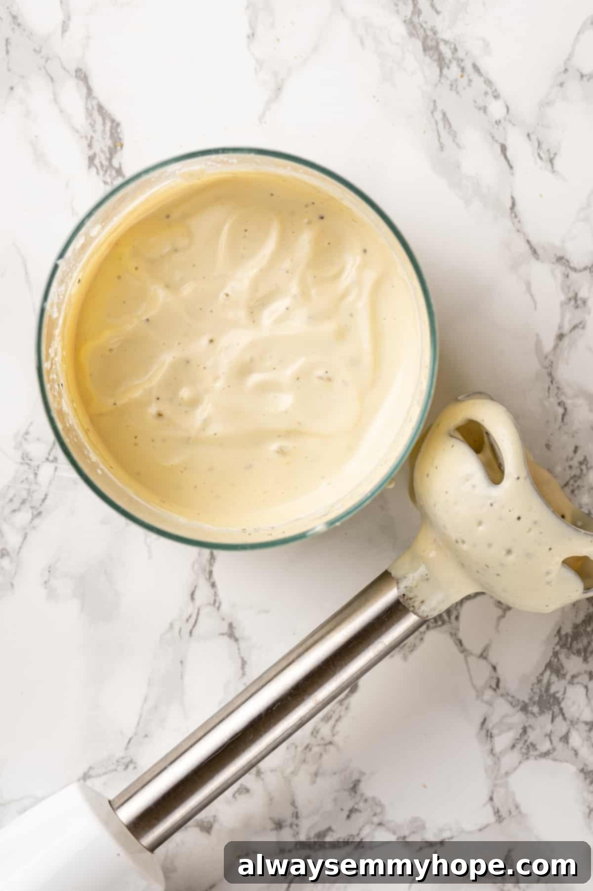 Silken Tofu for Creamy Vegan Mayonnaise and Dressings Vegan mayonnaise in a mini blender container, ready to be blended with a hand blender, highlighting silken tofu's creamy texture.