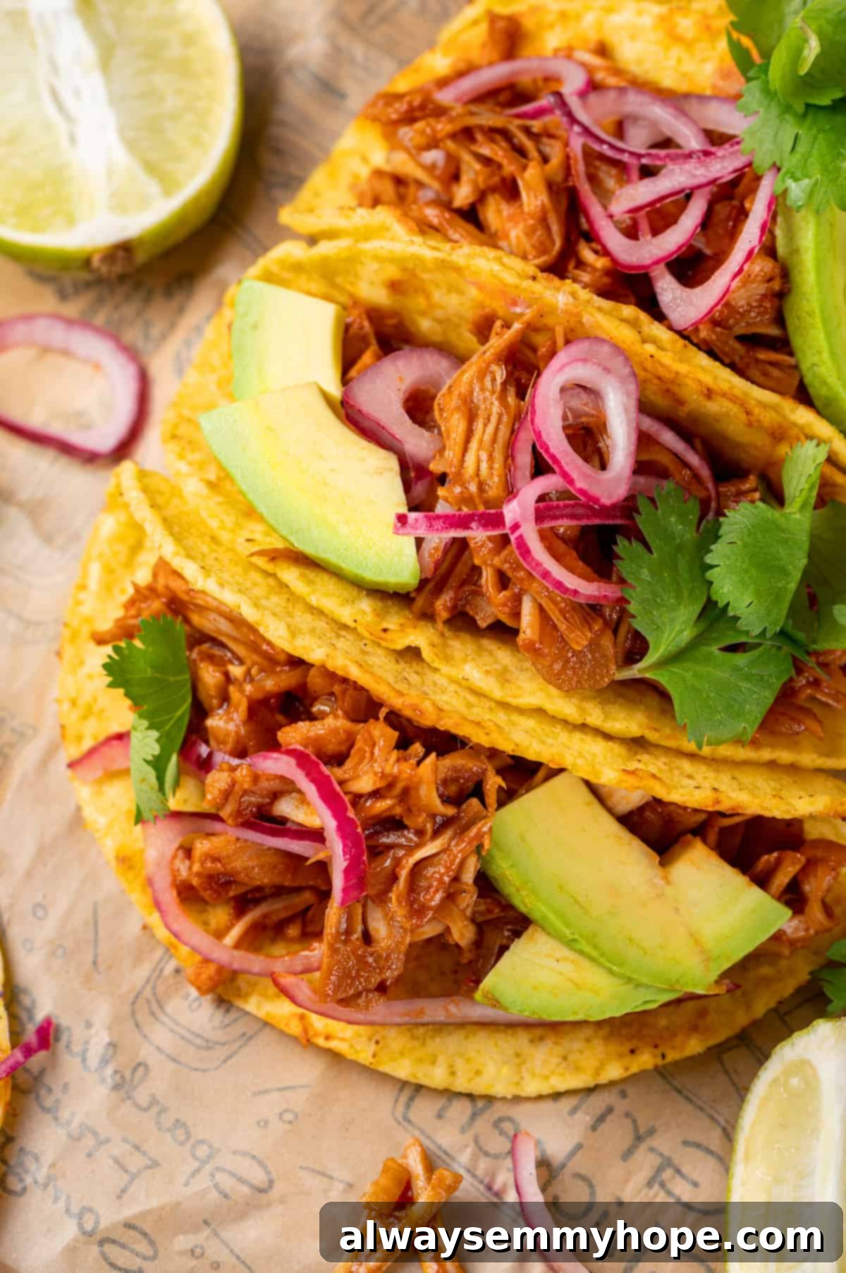 3 jackfruit tacos on printed parchment paper