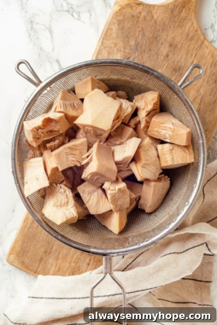 Overhead view of unripe canned jackfruit in colander