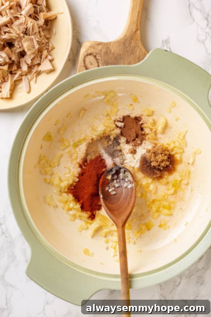 Overhead view of onion and spices in pan