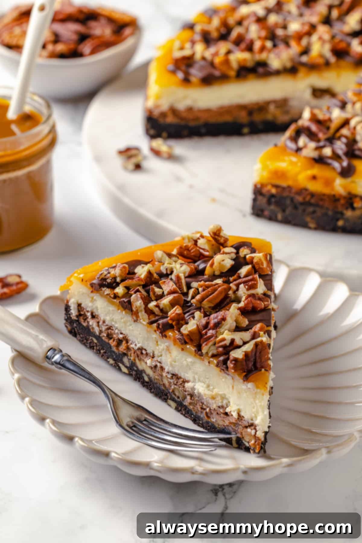 Slice of turtle cheesecake on plate with remaining cheesecake in background