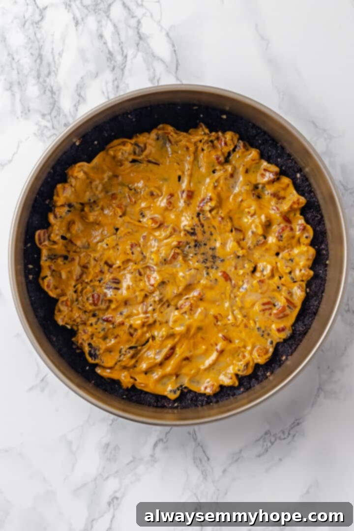 Overhead view of caramel layer spread over crust