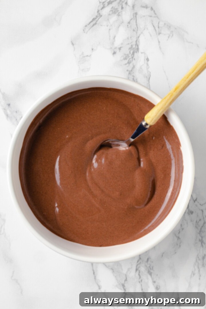 Vegan protein pudding mixture in mixing bowl with spoon