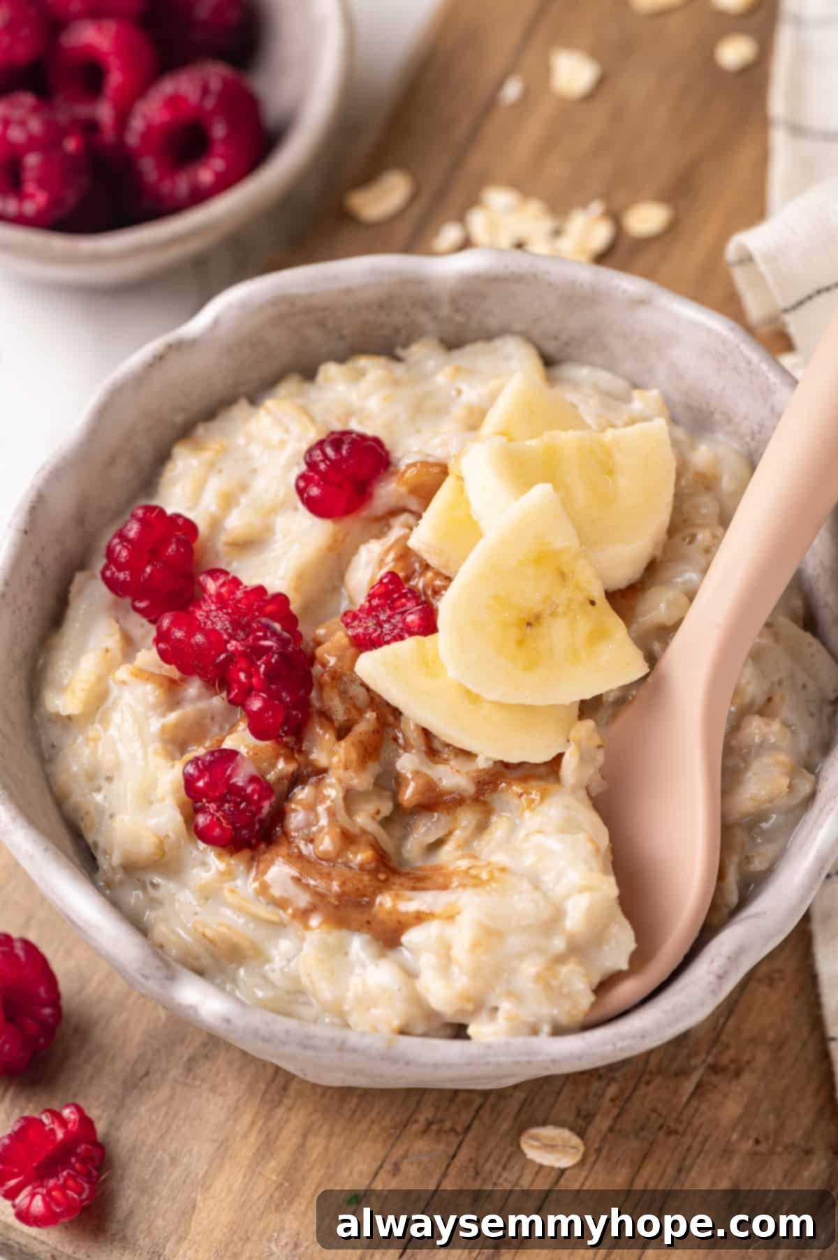 Baby oatmeal in bowl with banana, peanut butter, and berries, showcasing a healthy start to solids.