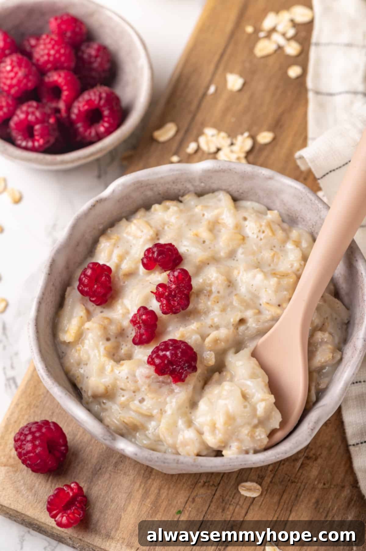 Baby oatmeal in a bowl with a spoon, highlighting its creamy texture and readiness for feeding.