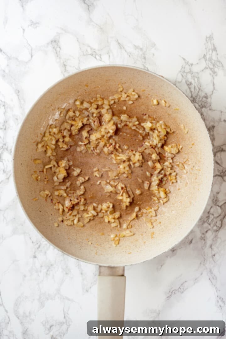 Overhead view of cooked onion in pan