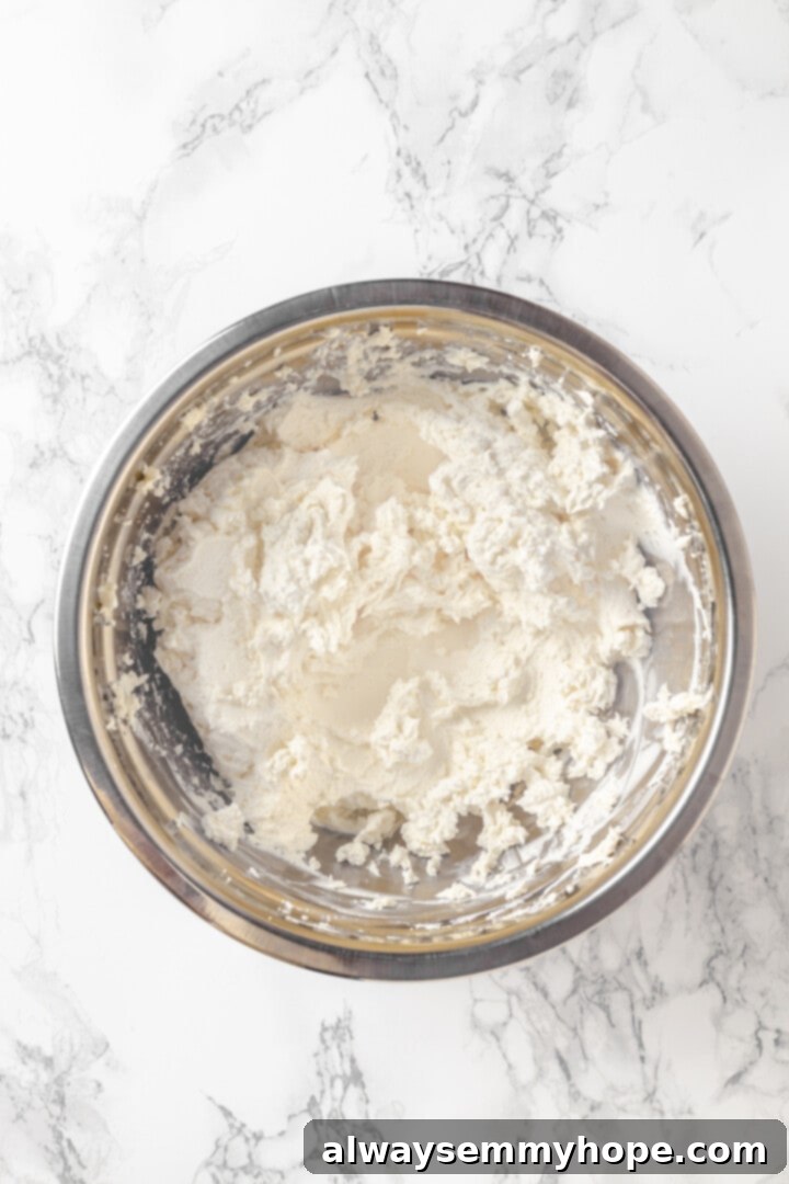 With cream cheese, pesto, Parmesan, and sun-dried tomatoes, these easy pinwheel sandwiches are full of flavour. Great for a party or lunch! Overhead view of whipped vegan cream cheese in bowl