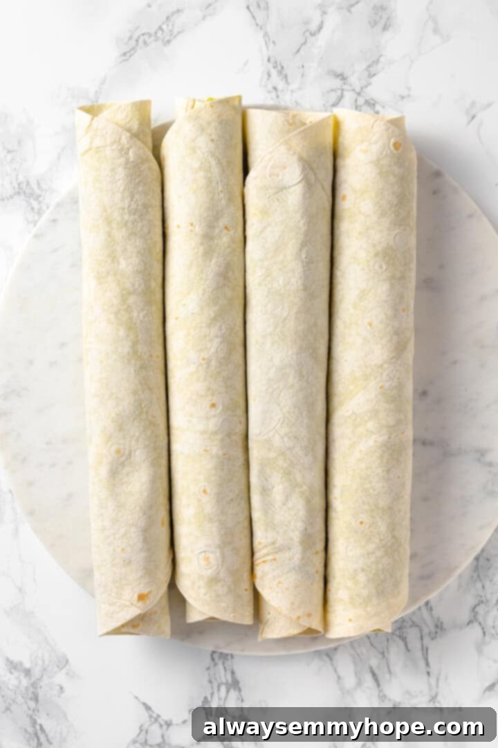 With cream cheese, pesto, Parmesan, and sun-dried tomatoes, these easy pinwheel sandwiches are full of flavour. Great for a party or lunch! Rolled up tortillas for pinwheels