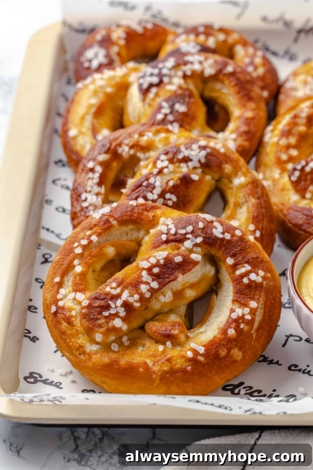 This soft pretzel recipe is fun to make and the results are outstanding—chewy, buttery, and perfect to serve with your fave dipping sauce! Tray of soft pretzels