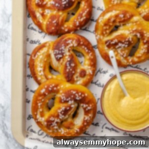 Bakery-Style Soft Pretzels 2 Overhead view of vegan soft pretzels on tray with beer cheese in bowl