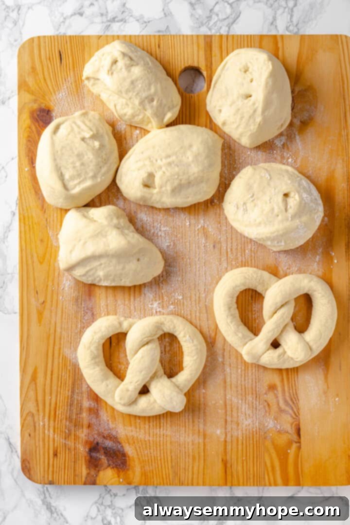 This soft pretzel recipe is fun to make and the results are outstanding—chewy, buttery, and perfect to serve with your fave dipping sauce! Overhead view of soft pretzels and dough on cutting board