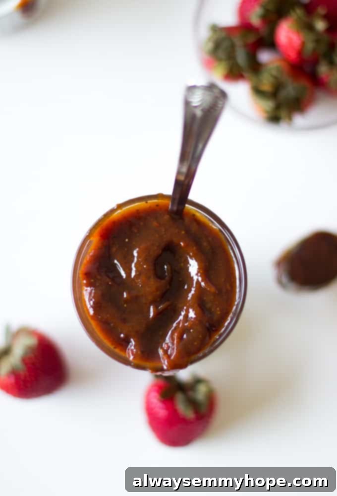Top down shot of roasted strawberry barbecue sauce, showcasing its vibrant color and smooth texture.